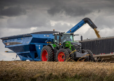 A Brandt grain handling transport belt assists in the harvesting process on an agriculture field.