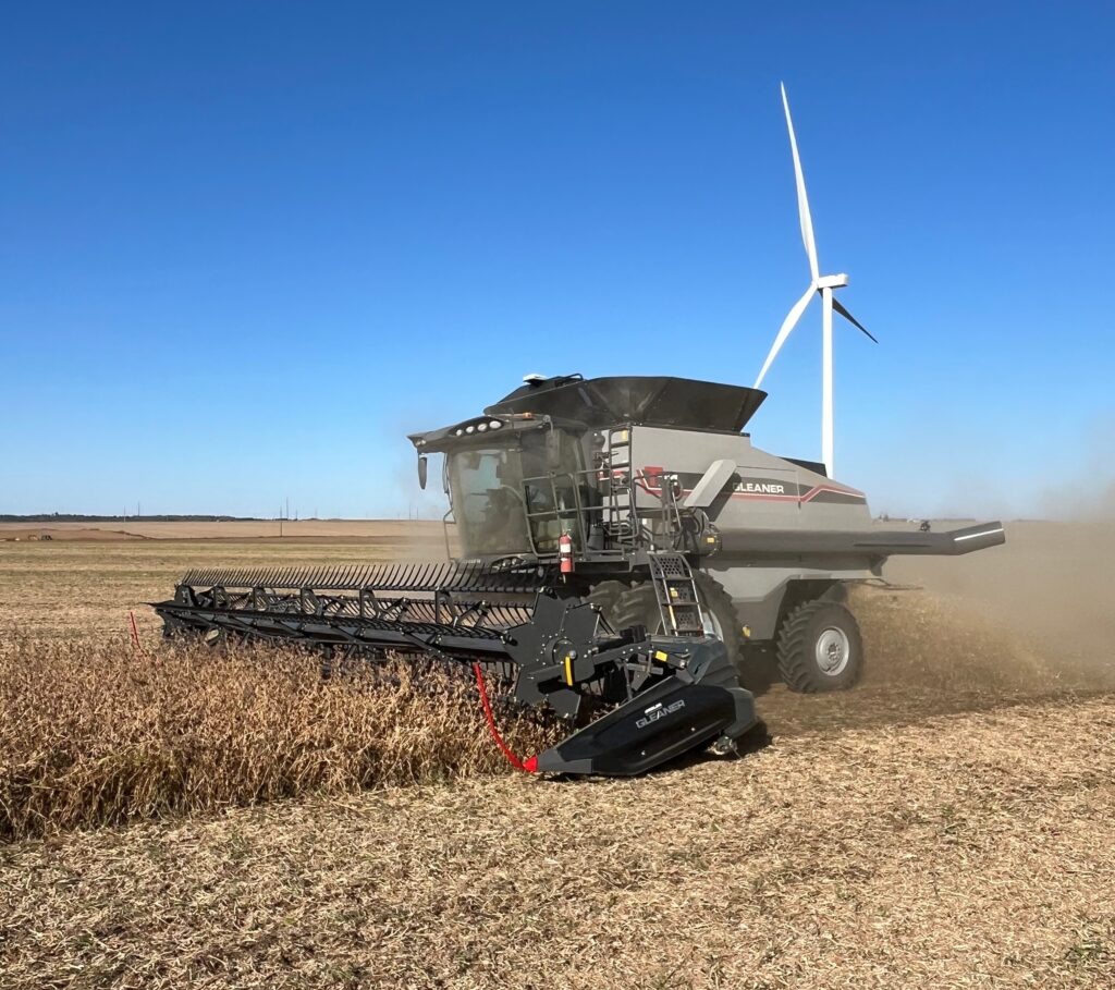fendt tractor in a field, towing an implement on a sunny day